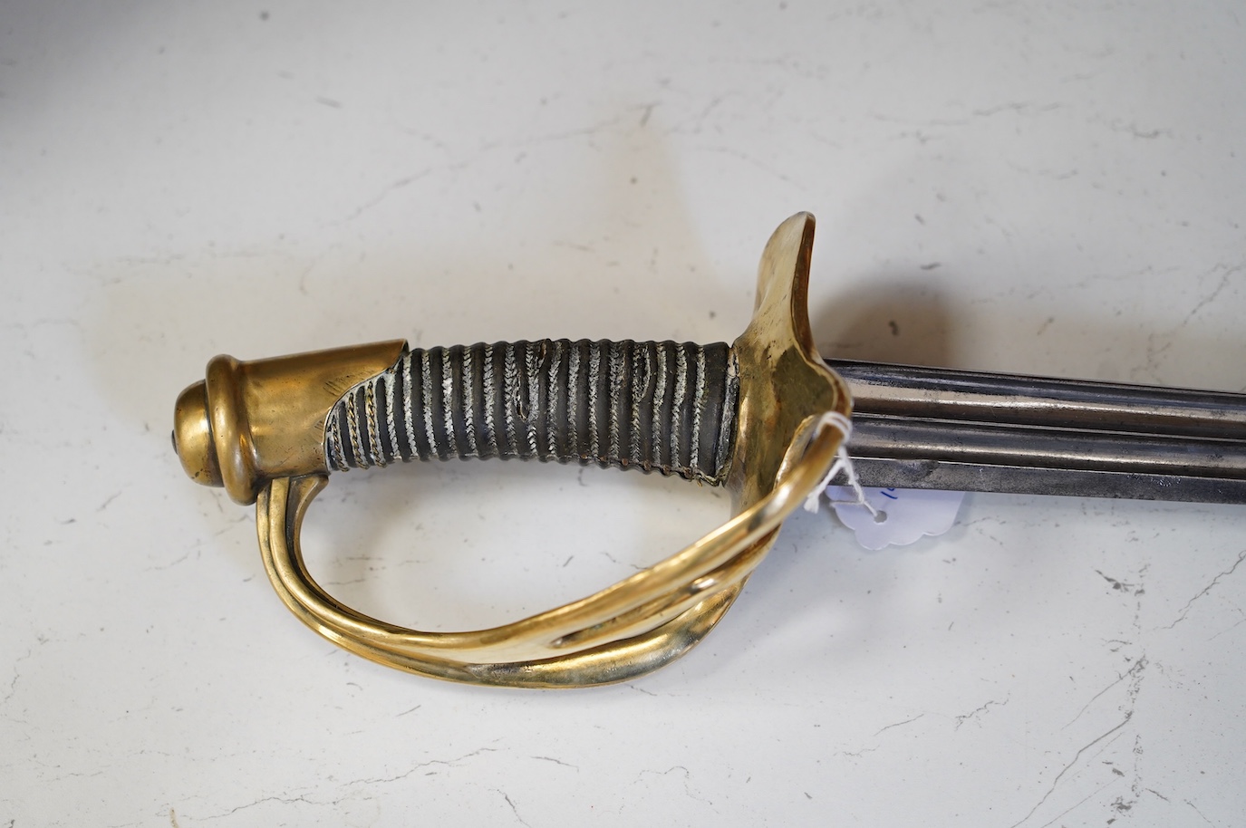 An 1854 Cuirassier's sword double fullered blade, blade faintly etched 1894? brass guard deformed, blade 94cm. Condition - fair